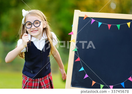 Cute little schoolgirl feeling excited about going back to school Cute little schoolgirl feeling excited about going back to school 33745678