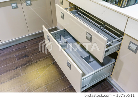 Opened kitchen drawer with plates for kitchen 33750511
