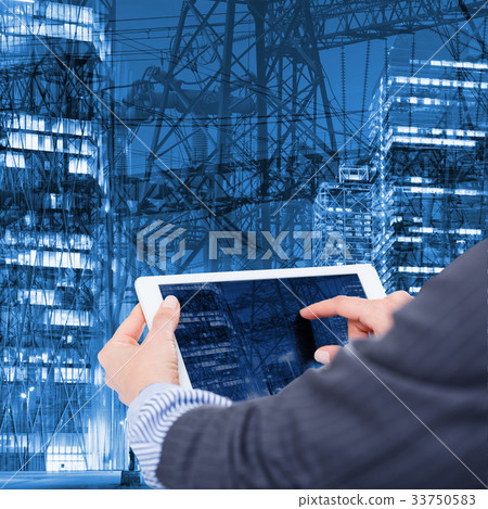 Female hands with tablet on industrial background 33750583