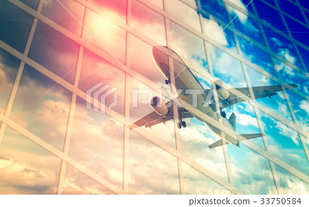 Airplane reflected in skyscrapers 33750584