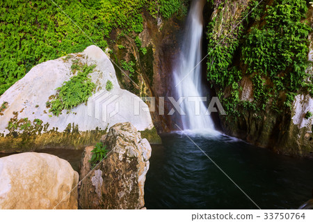 Waterfall in natural grot Waterfall in natural grot 33750764