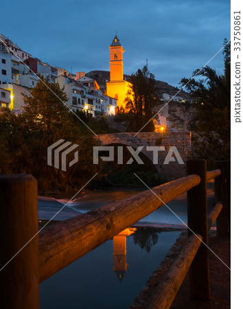 night view of Alcala del Jucar with bell tower and river night view of Alcala del Jucar with bell tower and river 33750861