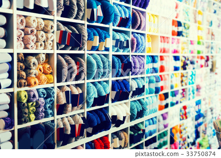 Shelves with colorful knitting yarn is staying 33750874