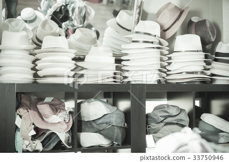 Stylish sun hats hanging on the shelf Stylish sun hats hanging on the shelf 33750946
