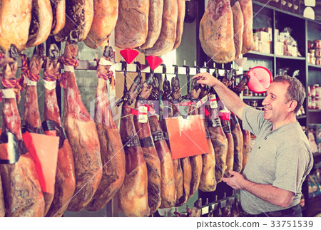 Customer buying iberico or serrano jamon leg 33751539