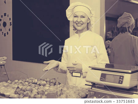 Happy woman posing in bakery with baguettes 33751683