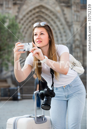 Young girl is taking photo on her phone Young girl is taking photo on her phone 33752139