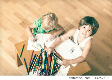 Siblings playing with pencils 33752598