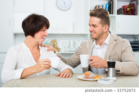 woman and man drinking tea with cakes woman and man drinking tea with cakes 33752672