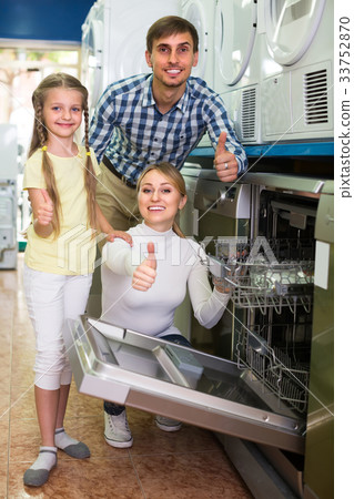 Family selecting dishwasher in store. Family selecting dishwasher in store. 33752870