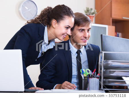 Managers flirting and smiling at work Managers flirting and smiling at work 33753118