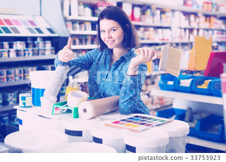 Girl 18-25 years old is purchasing tools for house improvements Girl 18-25 years old is purchasing tools for house improvements 33753923