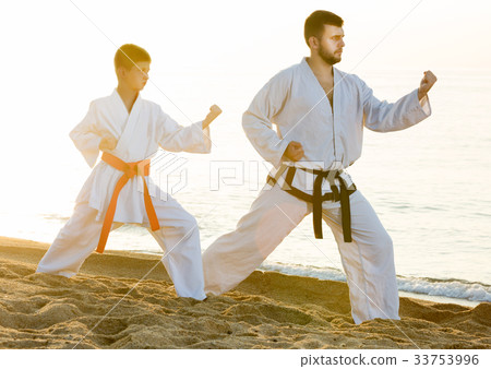 Man and boy exercising karate 33753996