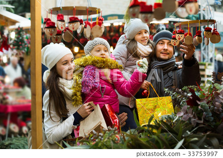 Family with children purchasing toys Family with children purchasing toys 33753997