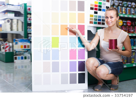 Cheerful adult woman picking color for paint Cheerful adult woman picking color for paint 33754197