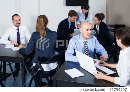 People working productively on business project together People working productively on business project together 33754207