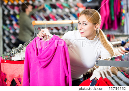 Girl choosing a sporty jacket 33754362