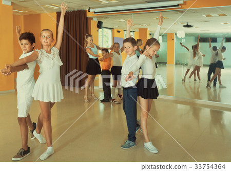 Group of children dancing tango in dance studio Group of children dancing tango in dance studio 33754364