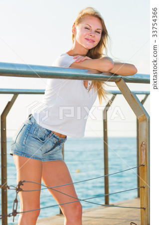 Elegant woman is posing on pirce in her free time 33754366