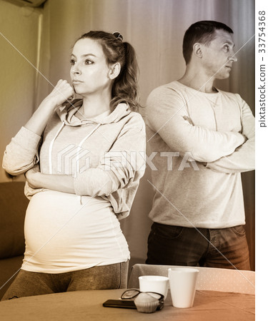 Husband and pregnant wife arguing at home Husband and pregnant wife arguing at home 33754368