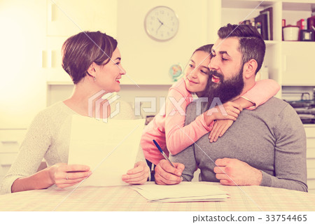 Parents signing property papers 33754465