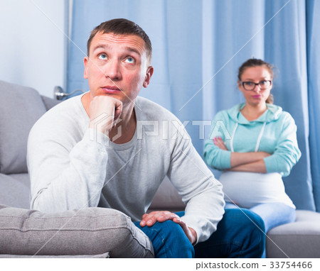 Husband and pregnant wife arguing at home Husband and pregnant wife arguing at home 33754466