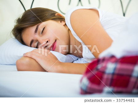 Charming girl sleeping in bed at home 33754481