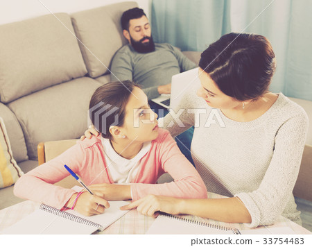 Mother helping daughter with homework Mother helping daughter with homework 33754483