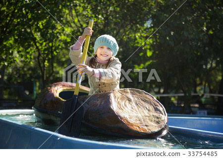 Little girl swims by boat Little girl swims by boat 33754485