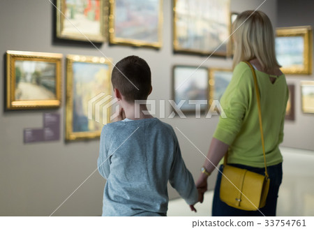 Mother and son looking at paintings in halls of museum Mother and son looking at paintings in halls of museum 33754761