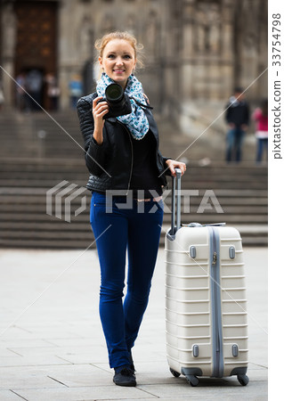 Young female traveller with camera 33754798