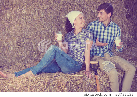 man and woman in hay with milk 33755155