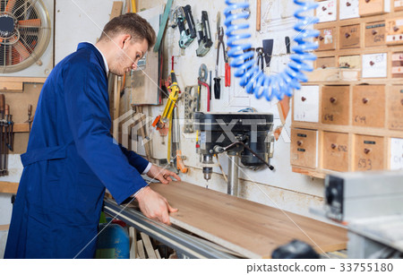 Young guy using machine to process plank 33755180