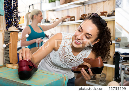 Young woman choosing a pair of shoes 33755299