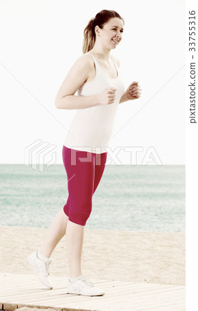 Woman running on beach 33755316