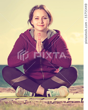 Laughing young woman training yoga Laughing young woman training yoga 33755449