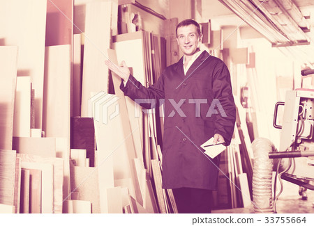 polite workman standing with plywood pieces polite workman standing with plywood pieces 33755664