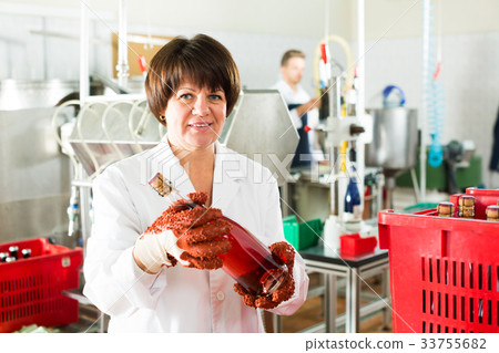 Female worker sorting wine bottles Female worker sorting wine bottles 33755682