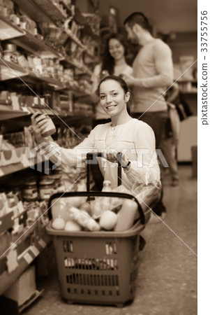 customers standing near shelves with canned goods at shop 33755756
