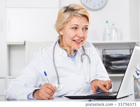 Doctor in gown waiting for patient Doctor in gown waiting for patient 33756371
