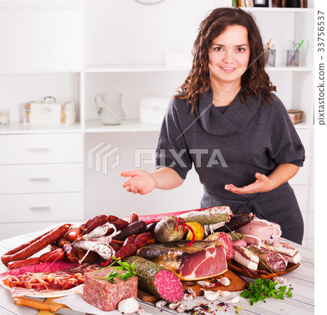 Woman stands with smoked products 33756537