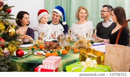 family celebrates Christmas at table family celebrates Christmas at table 33756721