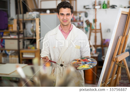 Man near easel painting on canvas Man near easel painting on canvas 33756887