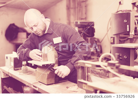 Man polishing wood on machine Man polishing wood on machine 33756926