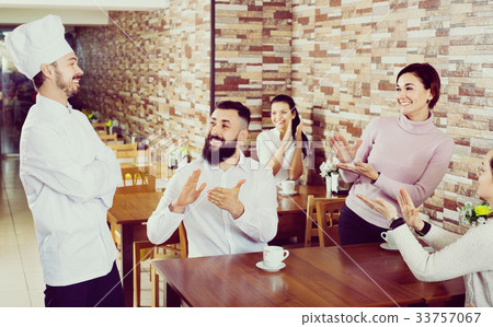 Happy chef listens to praise of the food 33757067