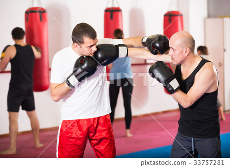 Ordinary sportsmen competing in boxing gloves 33757281