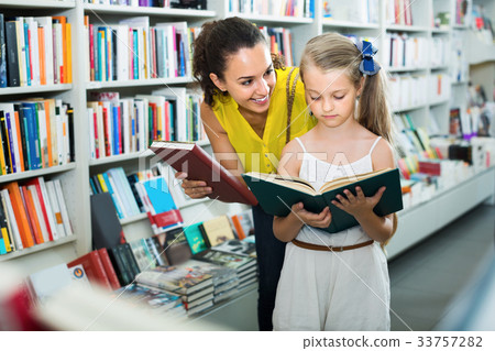 Smiling woman with child together in shop Smiling woman with child together in shop 33757282