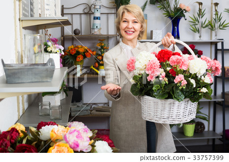 Glad female customer choosing flowers Glad female customer choosing flowers 33757399