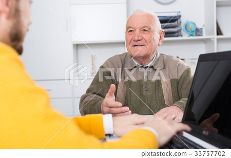 Man signing papers in office Man signing papers in office 33757702