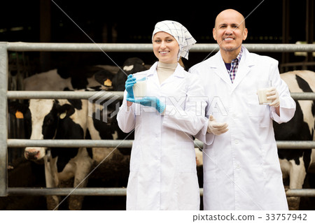 Portrait of two glad veterinarians wearing white coats Portrait of two glad veterinarians wearing white coats 33757942